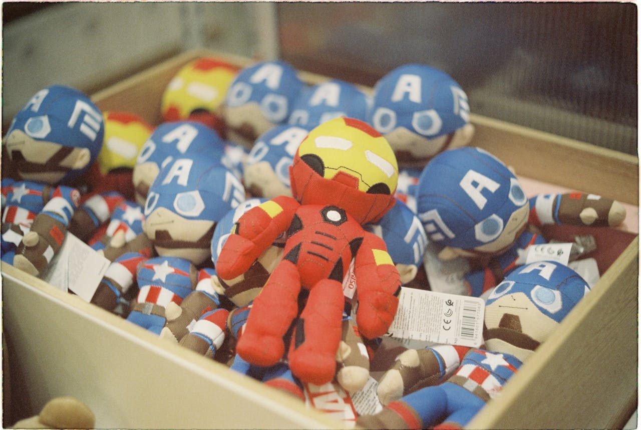 A vibrant collection of superhero dolls displayed in a box, bright and colorful.